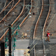 Two freight railway workers walk across train tracks.